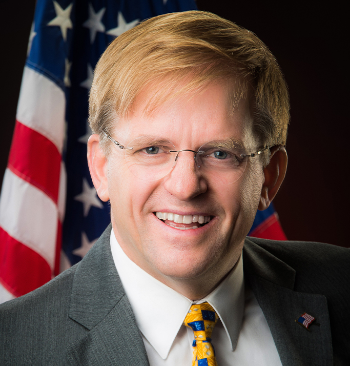 Dan Bohmer Headshot in front of American flag