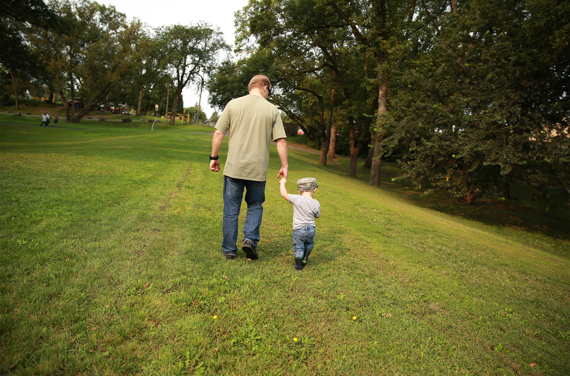 Dan Bohmer taking a walk with his grandson in a park